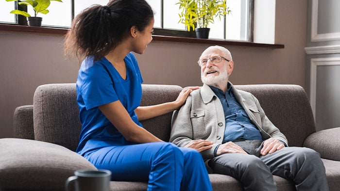 Female doctor and patient sitting down on a couch