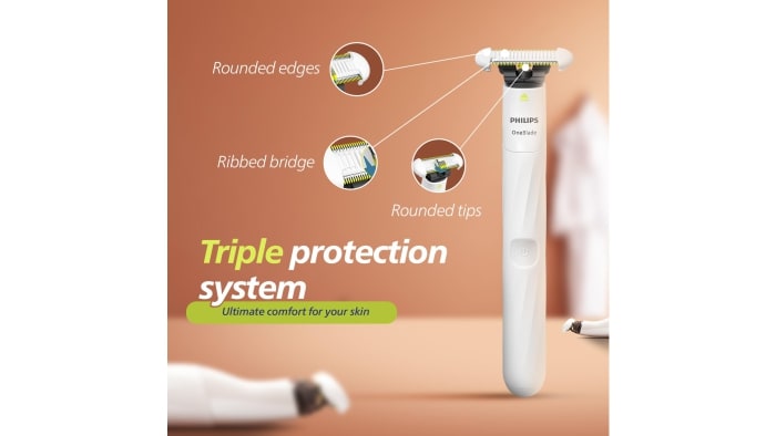 Product image highlighting Philips OneBlade Intimate’s “Triple protection system.” Labels point to rounded edges, ribbed bridge, and rounded tips on the blade. 
